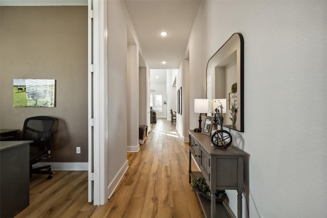 hall with light wood finished floors, recessed lighting, and baseboards