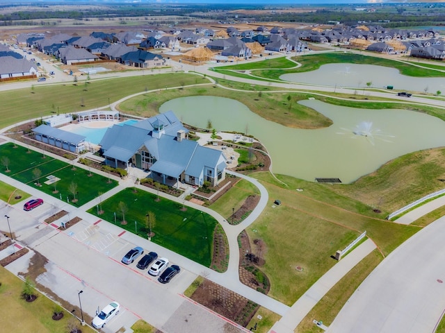 birds eye view of property with a residential view, a water view, and golf course view