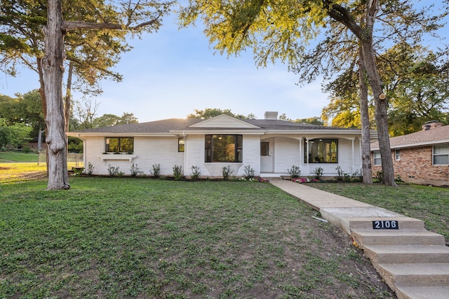 ranch-style home with a front lawn