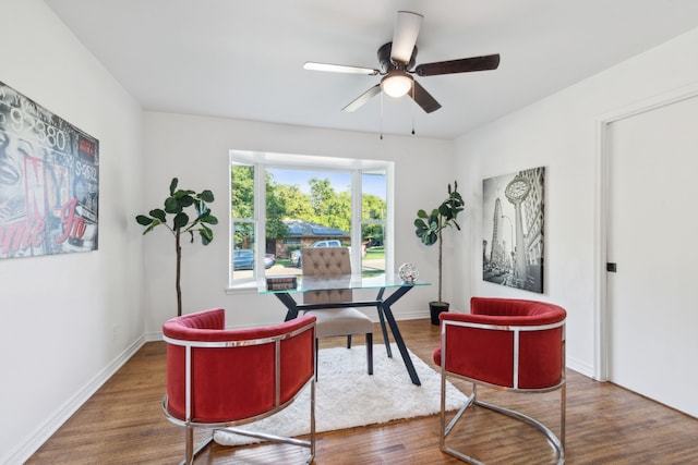 home office with ceiling fan and dark hardwood / wood-style flooring