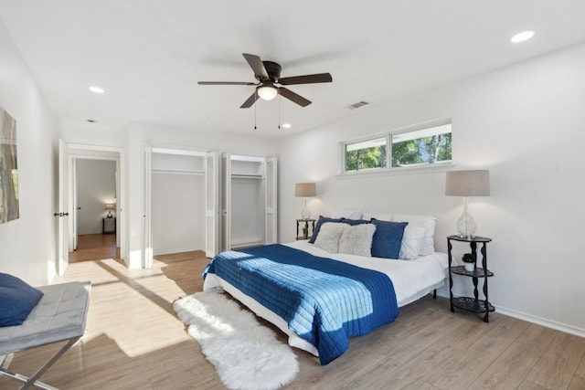 bedroom with light hardwood / wood-style floors and ceiling fan