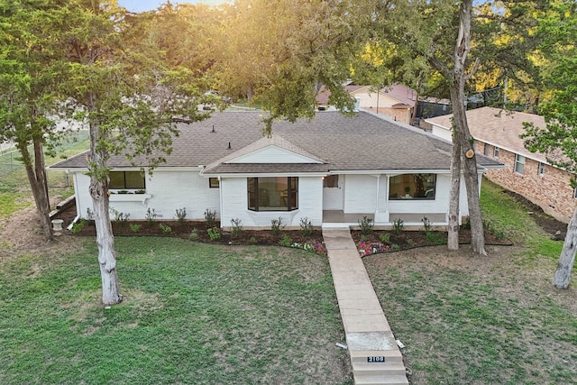 ranch-style house featuring a porch and a front lawn