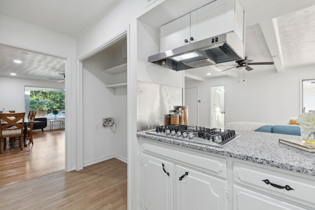 kitchen with white cabinets, stainless steel gas cooktop, light wood-type flooring, and ceiling fan