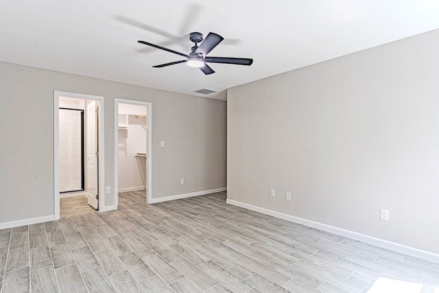 spare room with ceiling fan and light wood-type flooring