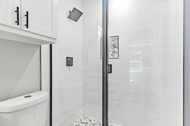 bathroom with walk in shower and toilet