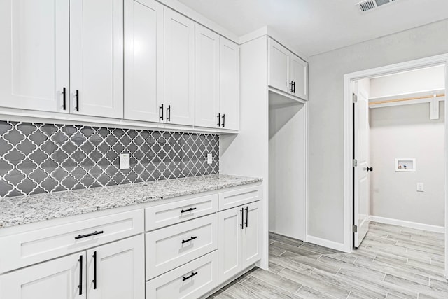 washroom with light hardwood / wood-style flooring