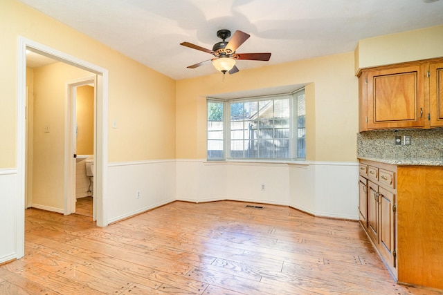 unfurnished dining area featuring ceiling fan and light hardwood / wood-style flooring