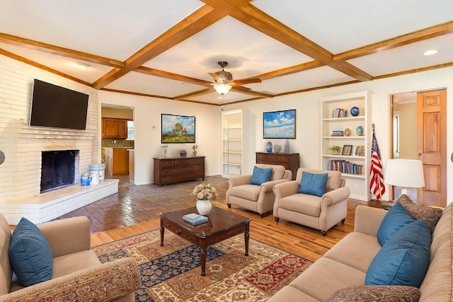 living room with a fireplace, built in features, ceiling fan, and coffered ceiling