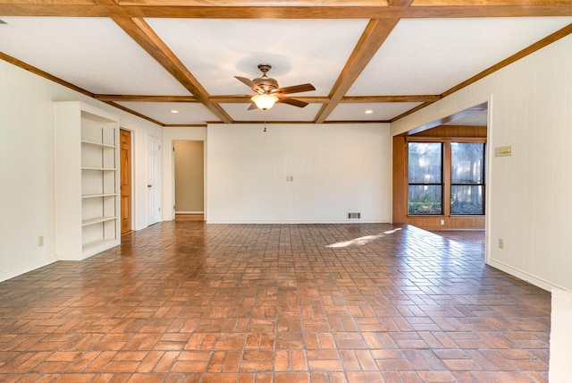 spare room with built in shelves, ceiling fan, beamed ceiling, and coffered ceiling