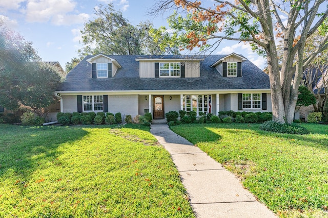 cape cod home with a front lawn