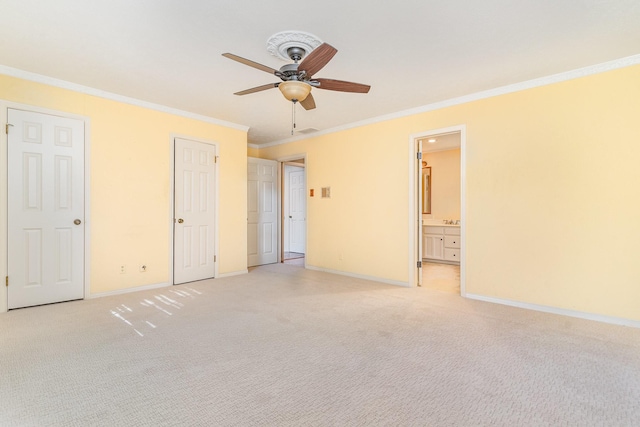 unfurnished bedroom with ensuite bathroom, ceiling fan, light colored carpet, and crown molding