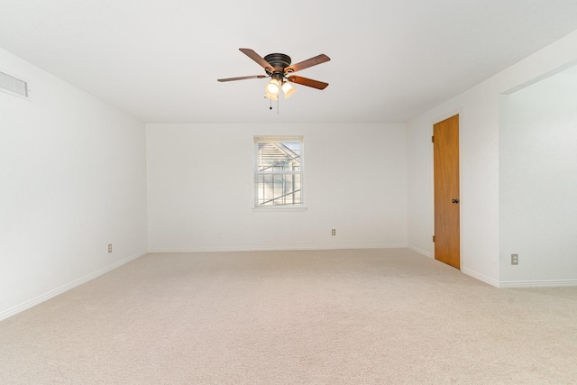 empty room with ceiling fan and light colored carpet