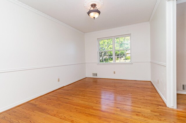 spare room with light hardwood / wood-style floors and ornamental molding