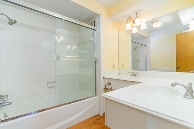 bathroom with vanity, wood-type flooring, and combined bath / shower with glass door