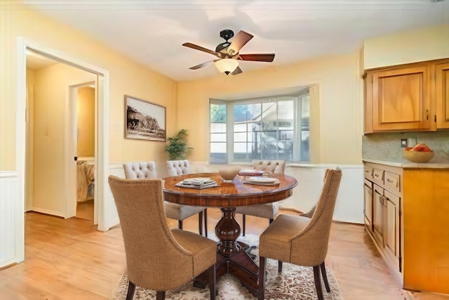 dining space featuring ceiling fan and light wood-type flooring