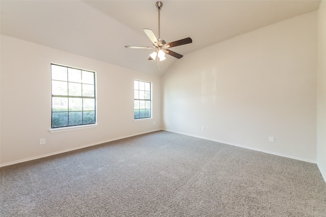 carpeted spare room featuring vaulted ceiling and ceiling fan