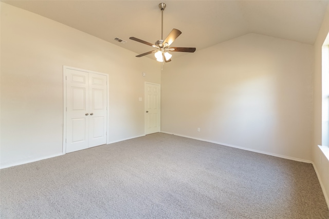 carpeted spare room with vaulted ceiling and ceiling fan