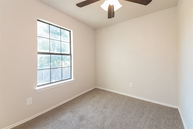 carpeted empty room featuring ceiling fan