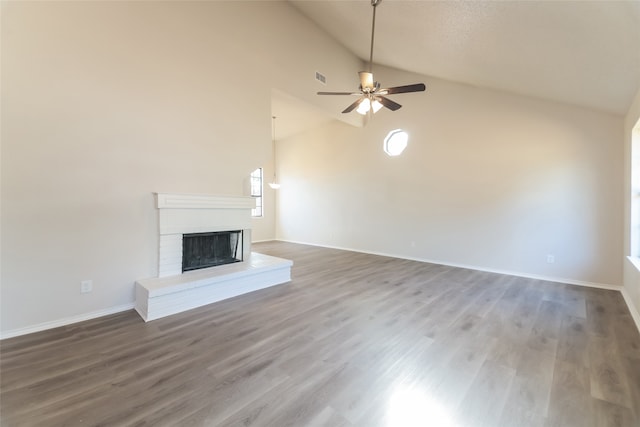 unfurnished living room featuring wood-type flooring, a brick fireplace, high vaulted ceiling, and ceiling fan