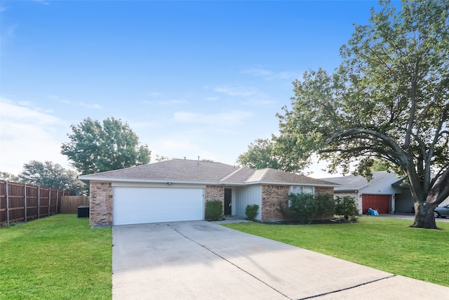 ranch-style house with a garage and a front lawn