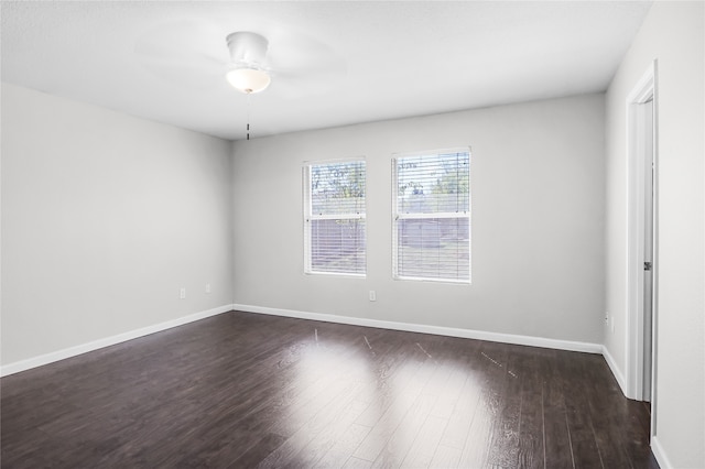 unfurnished room with dark wood-type flooring and ceiling fan