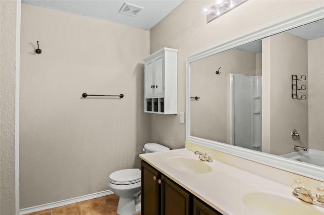 bathroom featuring tile patterned floors, vanity, a shower with door, and toilet