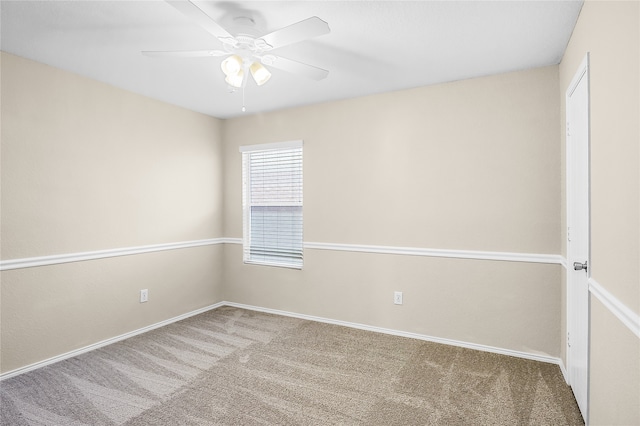 carpeted spare room featuring ceiling fan