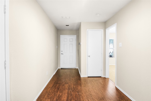 corridor featuring dark wood-type flooring