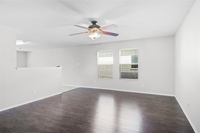 spare room featuring dark hardwood / wood-style floors, a textured ceiling, and ceiling fan