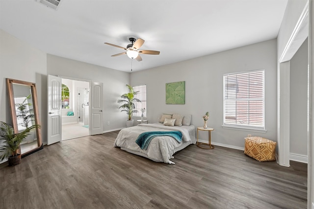 bedroom with dark hardwood / wood-style flooring, ceiling fan, and ensuite bathroom