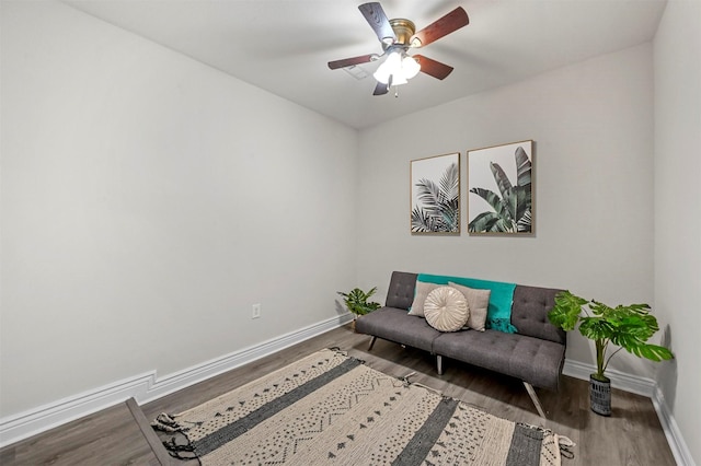 sitting room with wood-type flooring and ceiling fan