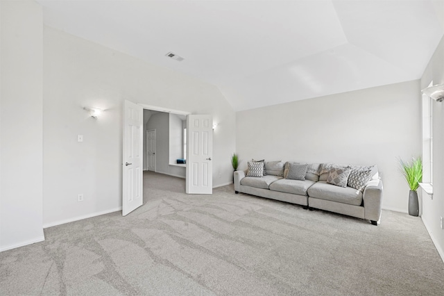 unfurnished living room with light carpet and vaulted ceiling