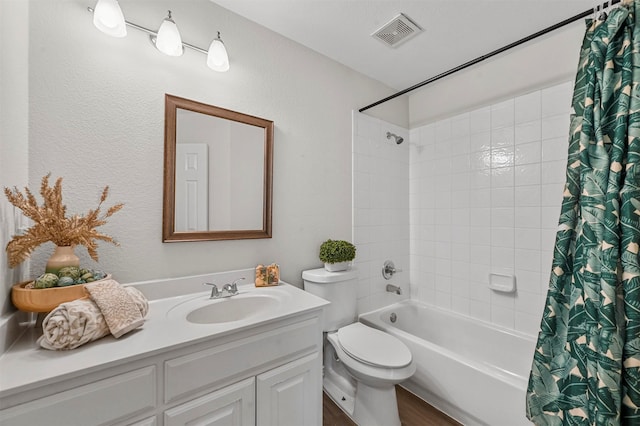 full bathroom featuring vanity, hardwood / wood-style flooring, toilet, and shower / tub combo with curtain