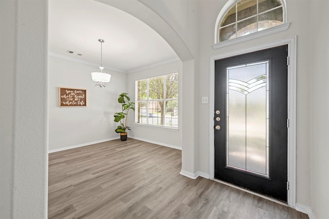 entrance foyer featuring light hardwood / wood-style flooring and ornamental molding