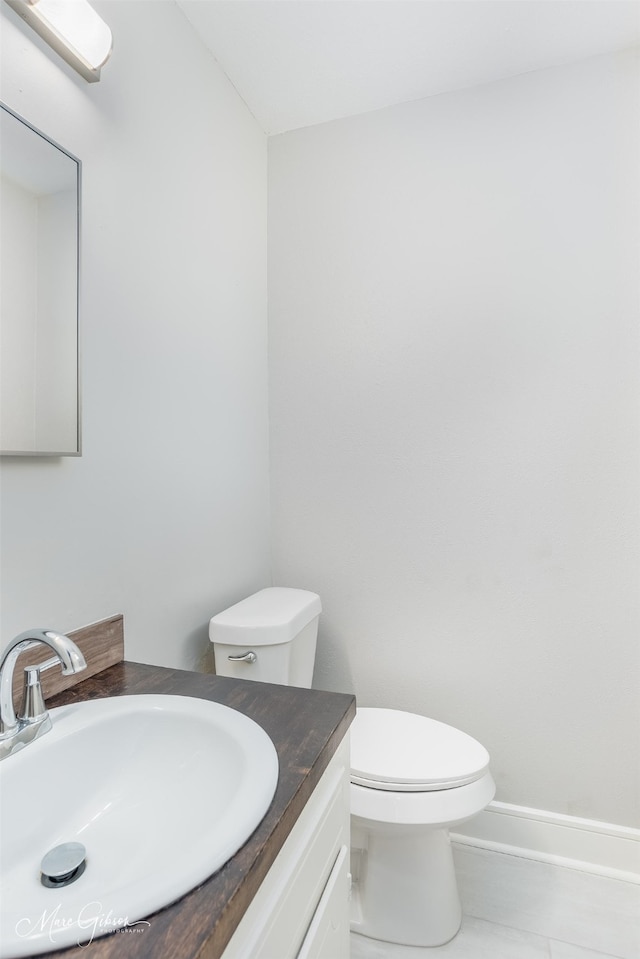 bathroom with vanity, toilet, and tile patterned floors