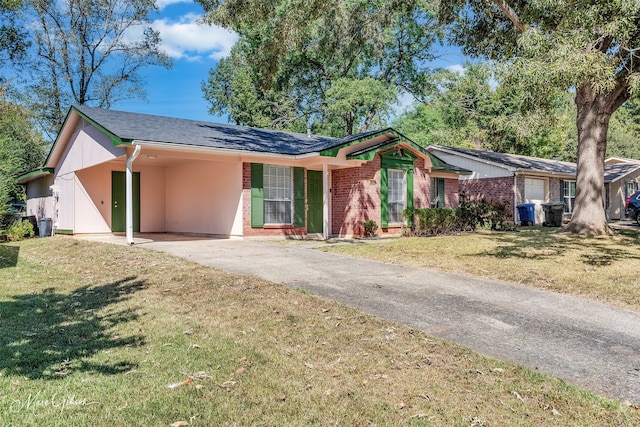 ranch-style home with a front yard and a carport