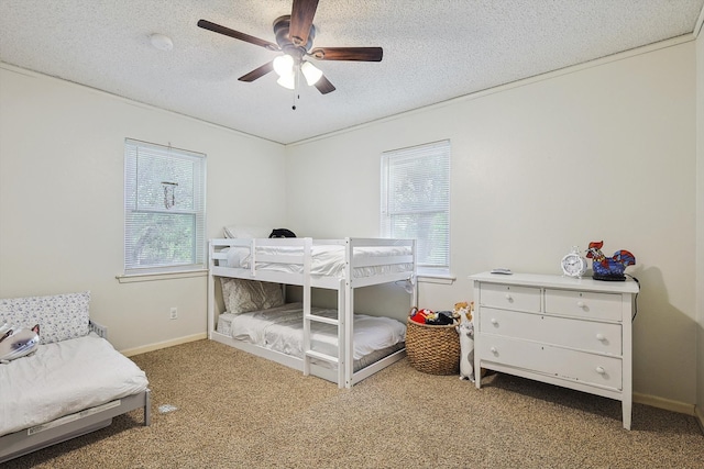 bedroom featuring carpet flooring, ceiling fan, and a textured ceiling