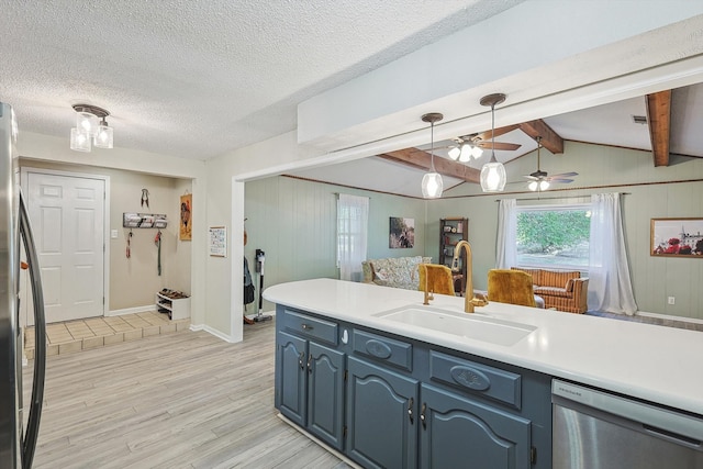 kitchen featuring lofted ceiling with beams, blue cabinets, sink, light hardwood / wood-style flooring, and appliances with stainless steel finishes