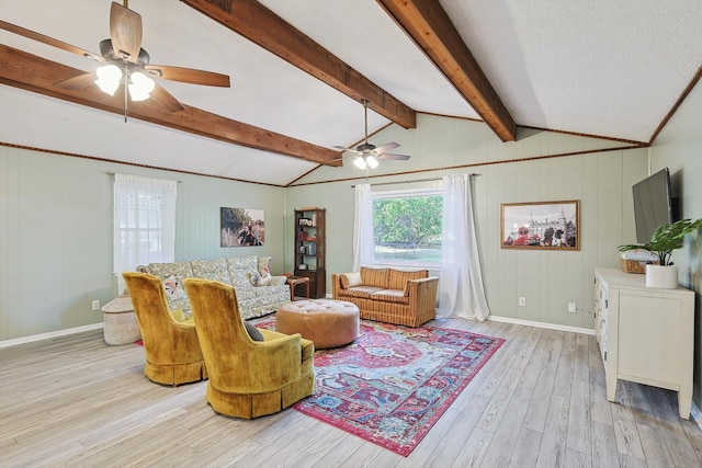 living room featuring vaulted ceiling with beams, light hardwood / wood-style floors, and ceiling fan