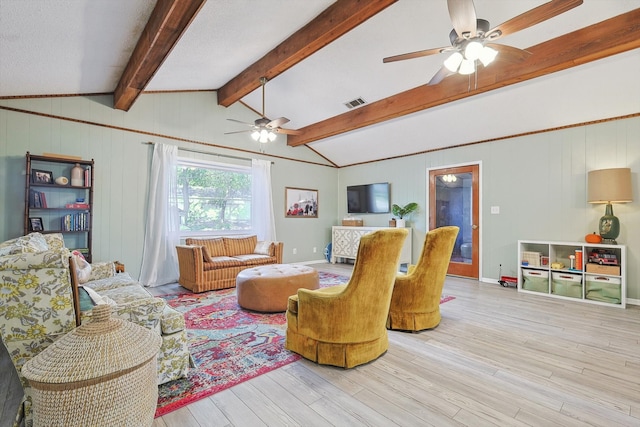 living room featuring light hardwood / wood-style flooring and lofted ceiling with beams