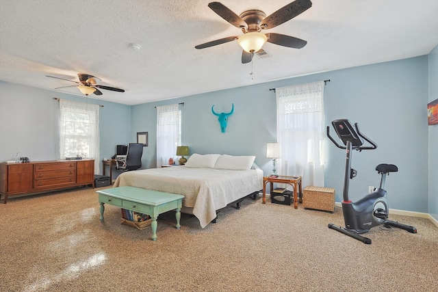 bedroom with ceiling fan and a textured ceiling