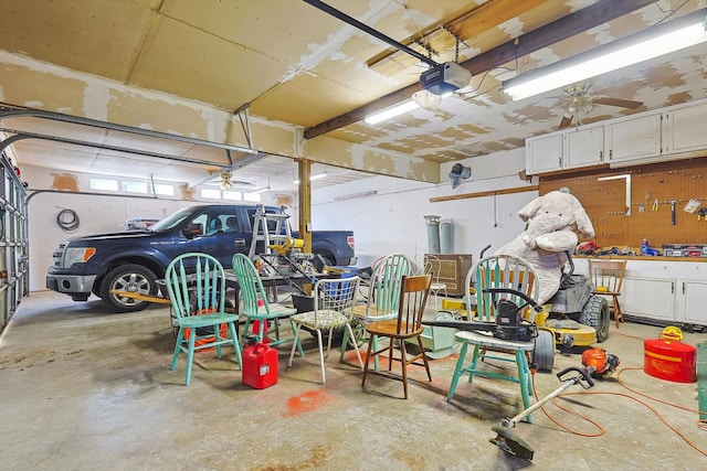 garage featuring a workshop area, ceiling fan, and a garage door opener