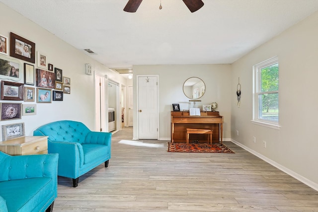 sitting room with ceiling fan and light hardwood / wood-style floors