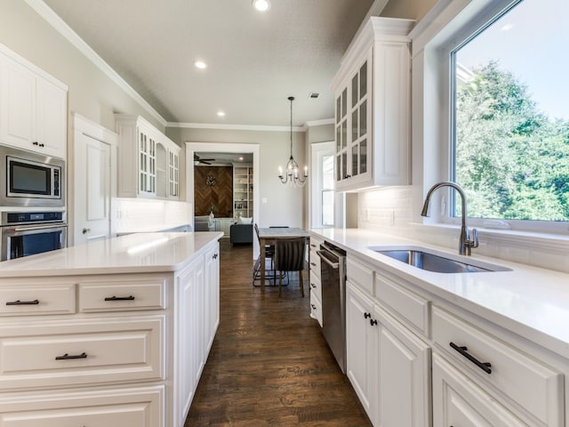 kitchen featuring stainless steel appliances, sink, white cabinetry, and a wealth of natural light