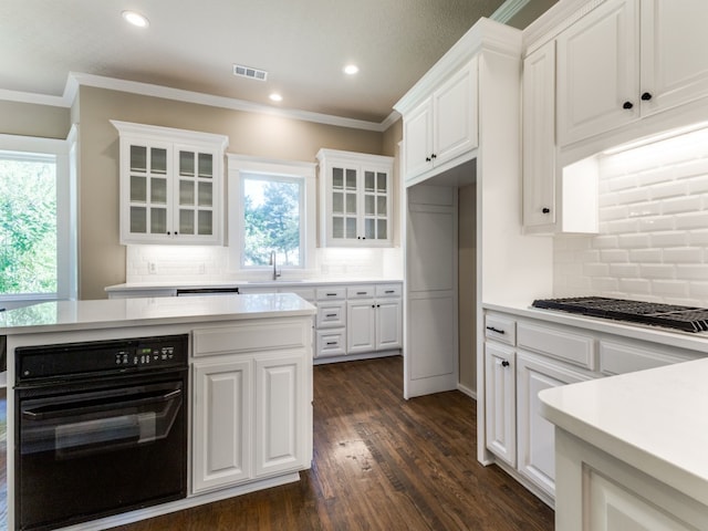 kitchen with white cabinets, dark hardwood / wood-style flooring, and a healthy amount of sunlight