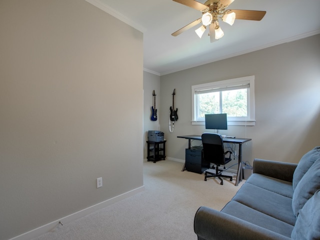 carpeted home office featuring crown molding and ceiling fan