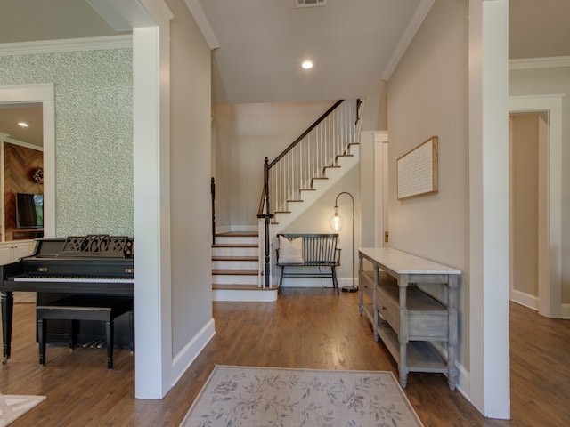 entryway with crown molding and dark wood-type flooring