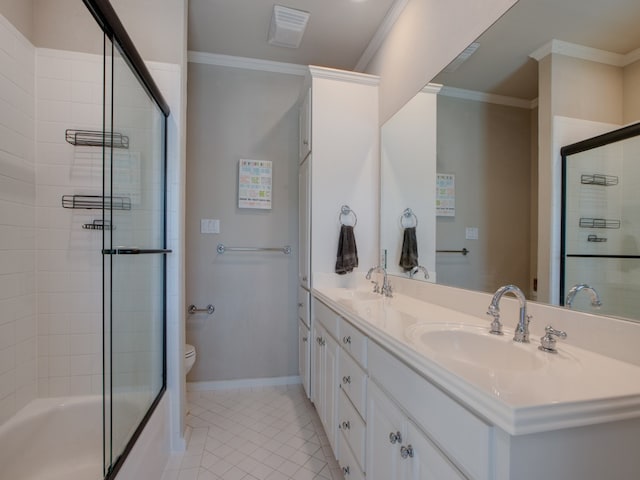 full bathroom with vanity, bath / shower combo with glass door, tile patterned floors, crown molding, and toilet