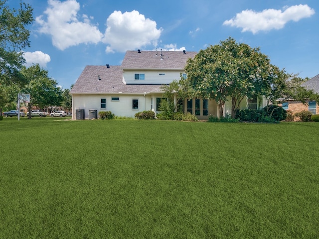 rear view of property featuring a lawn