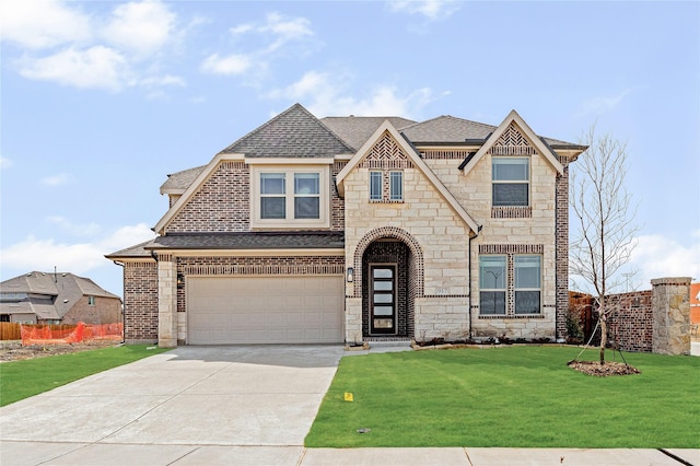 french country home with fence, driveway, roof with shingles, an attached garage, and a front lawn